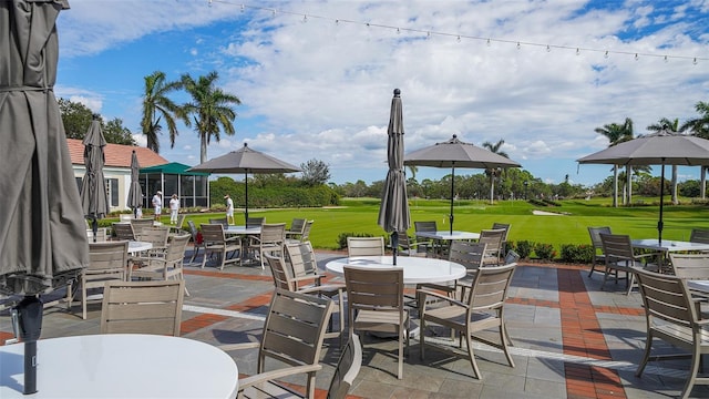 401 N Point Rd Unit 901, Osprey, FL 34229 - view of patio / terrace with outdoor dining space and view of golf course