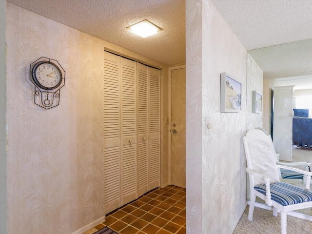 corridor with tile flooring and a textured ceiling