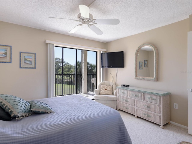 bedroom featuring light colored carpet, ceiling fan, and a textured ceiling