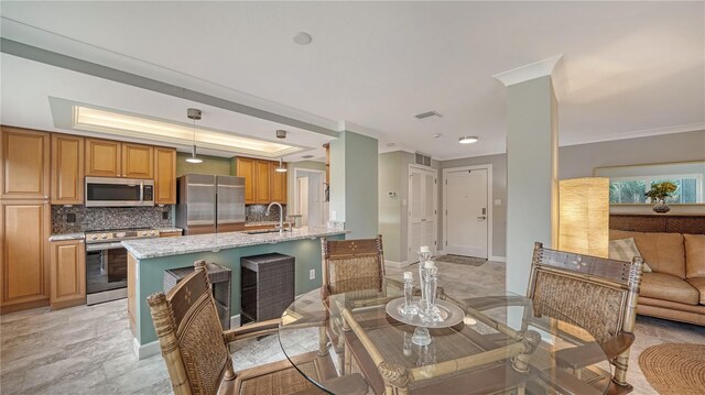 dining space featuring sink, crown molding, a raised ceiling, and light tile flooring