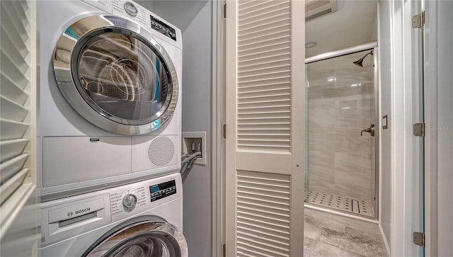 clothes washing area with hookup for a washing machine, light tile flooring, and stacked washer and dryer