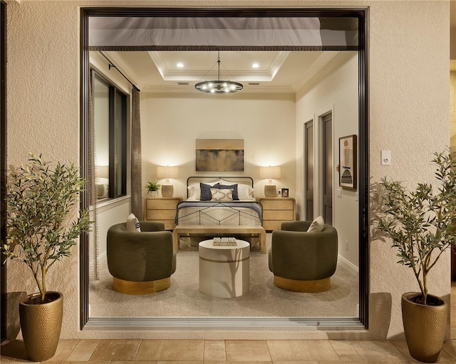 bedroom featuring a raised ceiling and crown molding