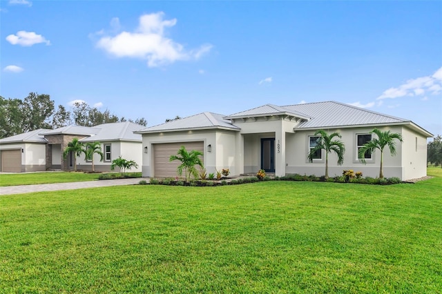 view of front of home featuring a front lawn and a garage