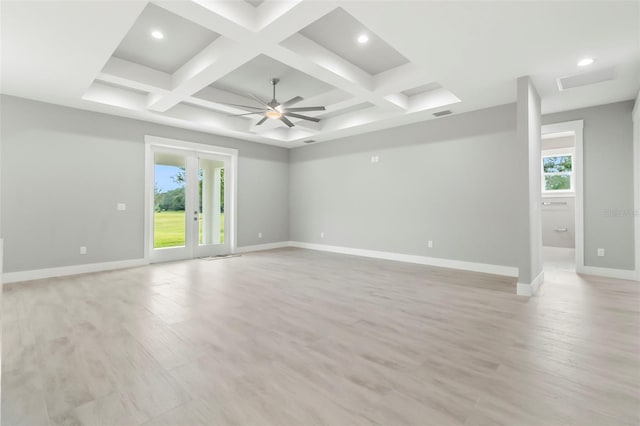 empty room with french doors, coffered ceiling, ceiling fan, and light wood-type flooring