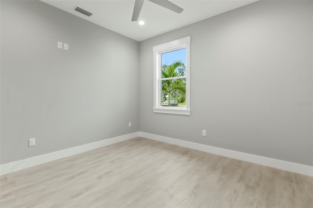 spare room with ceiling fan and light wood-type flooring