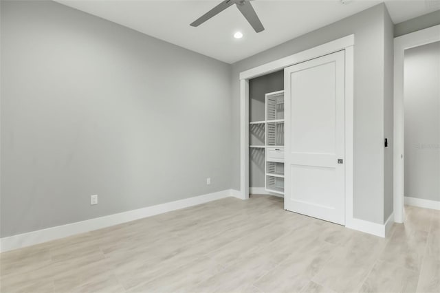 unfurnished bedroom with a closet, light hardwood / wood-style floors, and ceiling fan