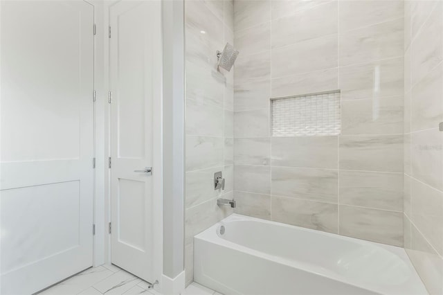 bathroom featuring tile floors and tiled shower / bath