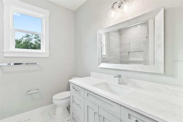 bathroom featuring toilet, tile flooring, and vanity