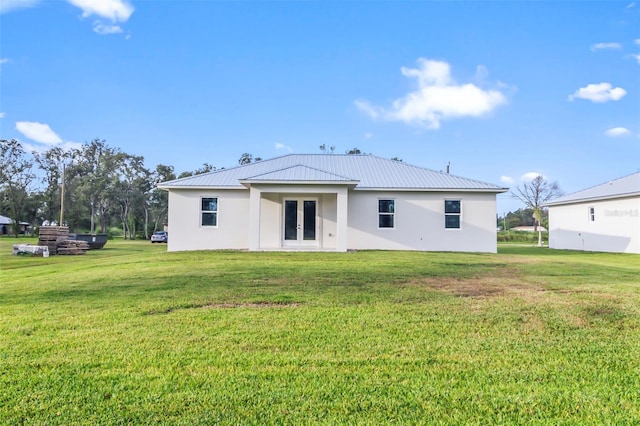 back of house featuring a lawn