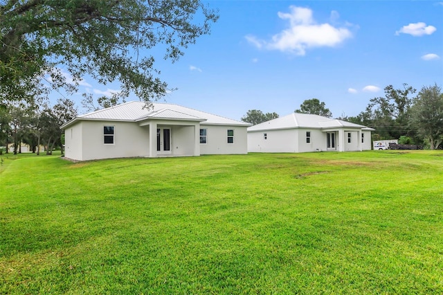 rear view of property with a yard