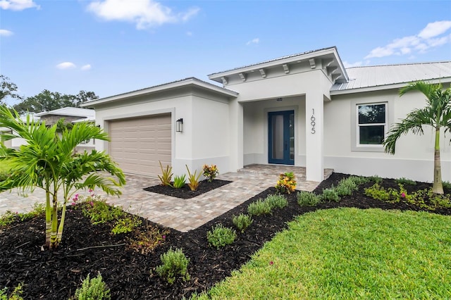 view of front of home with a front yard and a garage