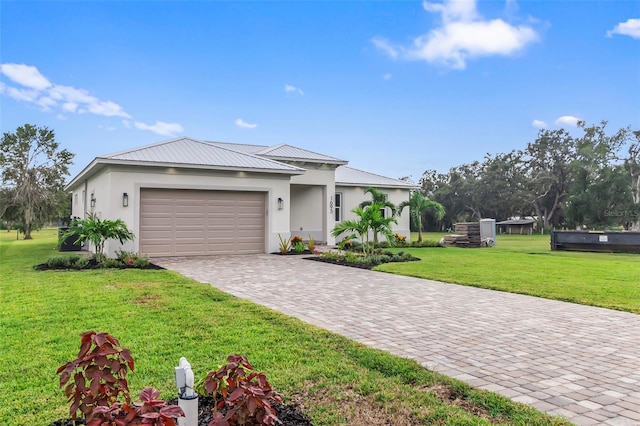 view of front of house with a front lawn and a garage