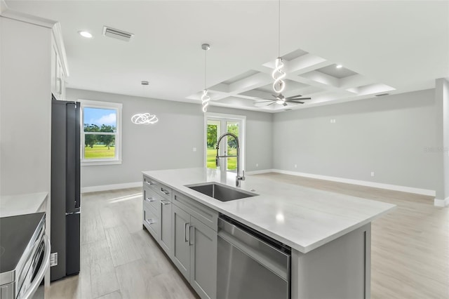 kitchen featuring ceiling fan, sink, stainless steel dishwasher, light hardwood / wood-style floors, and coffered ceiling