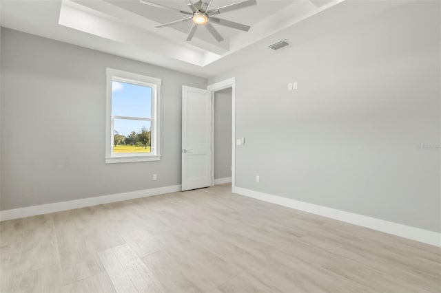 empty room featuring ceiling fan and light hardwood / wood-style flooring