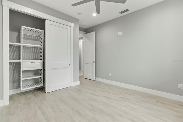 unfurnished bedroom featuring light hardwood / wood-style floors, a closet, and ceiling fan