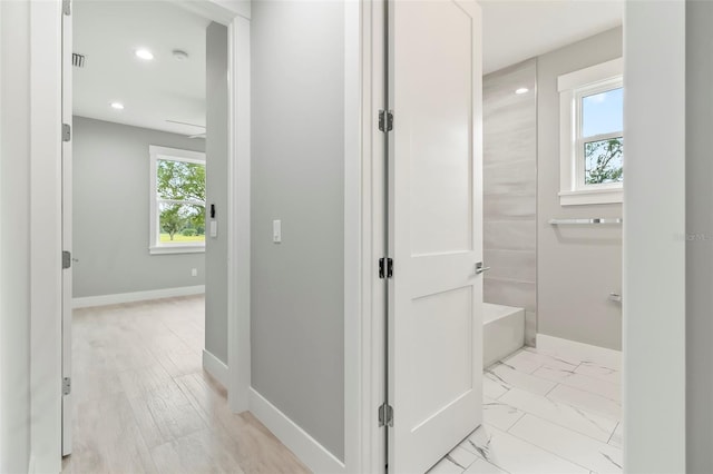 corridor with light hardwood / wood-style floors