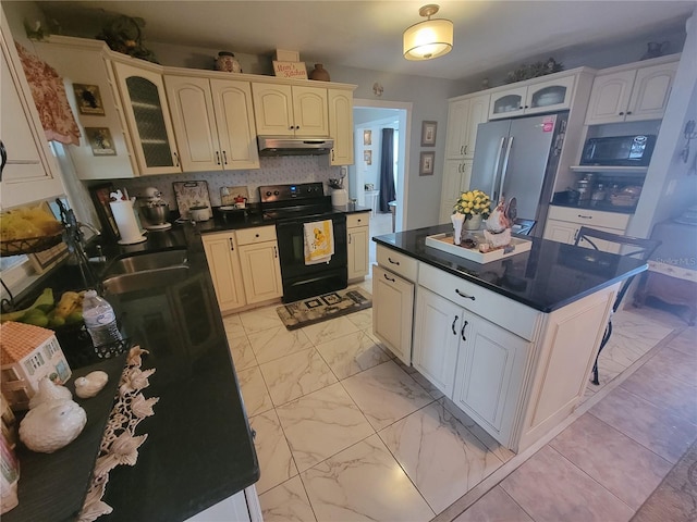 kitchen with backsplash, black appliances, light tile flooring, white cabinets, and a kitchen island