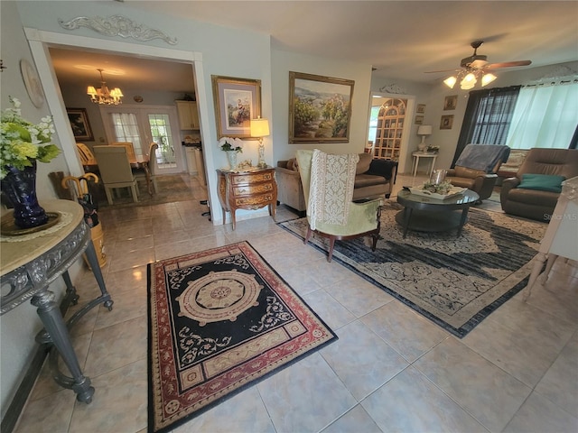 living room with ceiling fan with notable chandelier and light tile flooring
