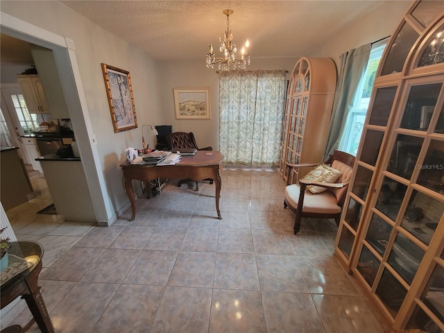 tiled home office with a textured ceiling and a notable chandelier
