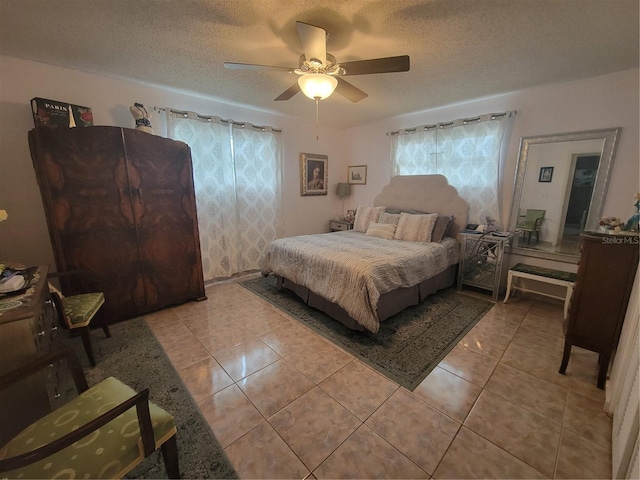 bedroom with light tile floors, a textured ceiling, and ceiling fan