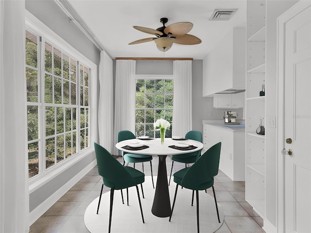 dining space with light tile flooring and ceiling fan