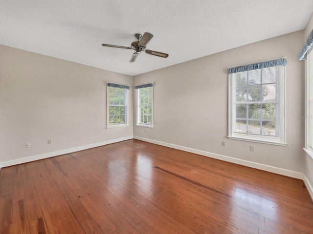 unfurnished room with dark hardwood / wood-style floors, a textured ceiling, and ceiling fan