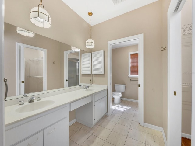 bathroom with toilet, double sink vanity, and tile flooring