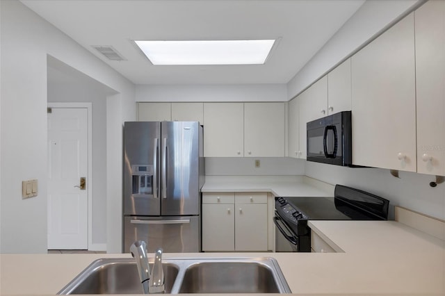 kitchen with sink, white cabinetry, and black appliances