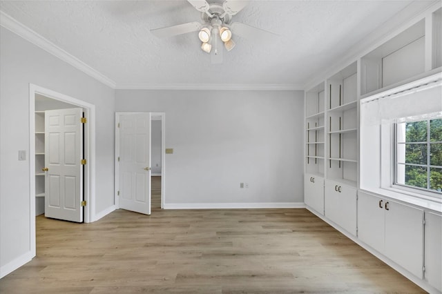 spare room with light hardwood / wood-style flooring, crown molding, ceiling fan, and a textured ceiling