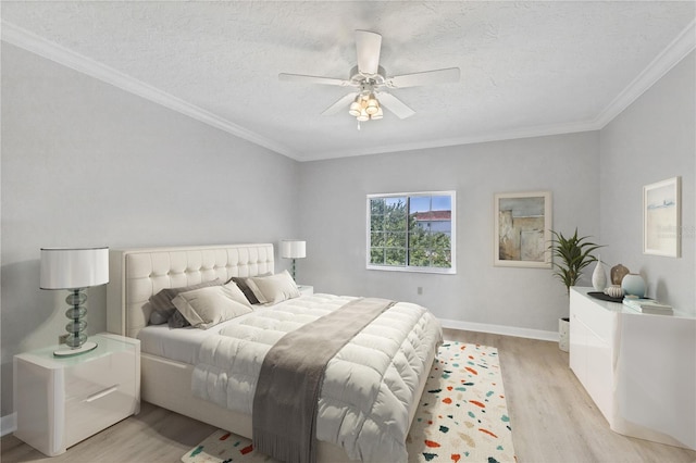 bedroom featuring crown molding, light hardwood / wood-style flooring, ceiling fan, and a textured ceiling