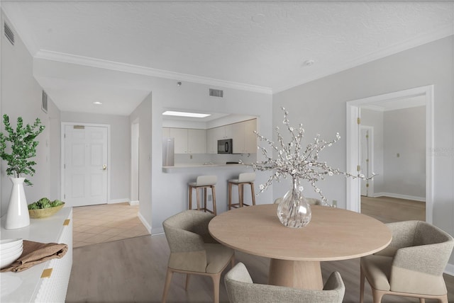 tiled dining room with ornamental molding