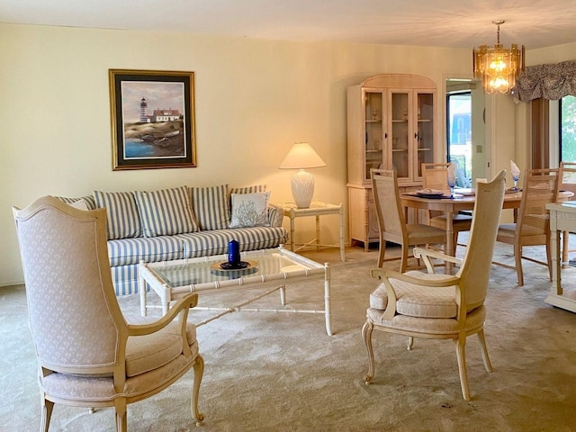 carpeted living room featuring a chandelier