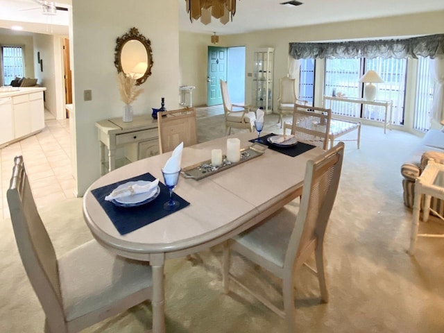 dining room with light tile patterned floors and ceiling fan