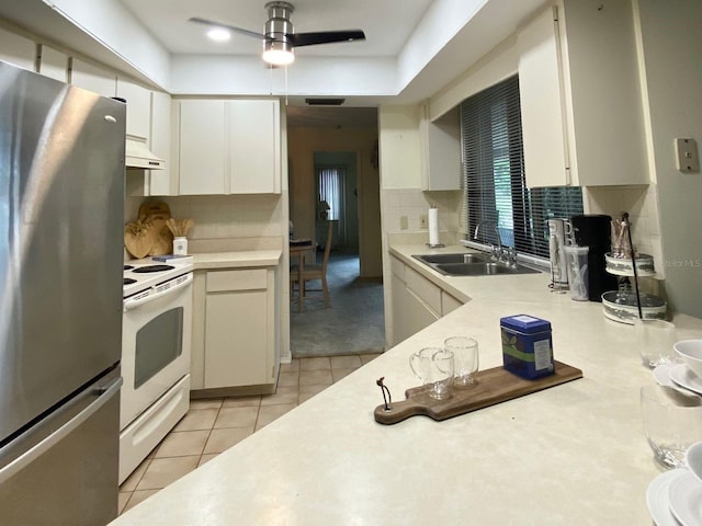 kitchen with premium range hood, sink, stainless steel fridge, white electric range oven, and light tile patterned flooring