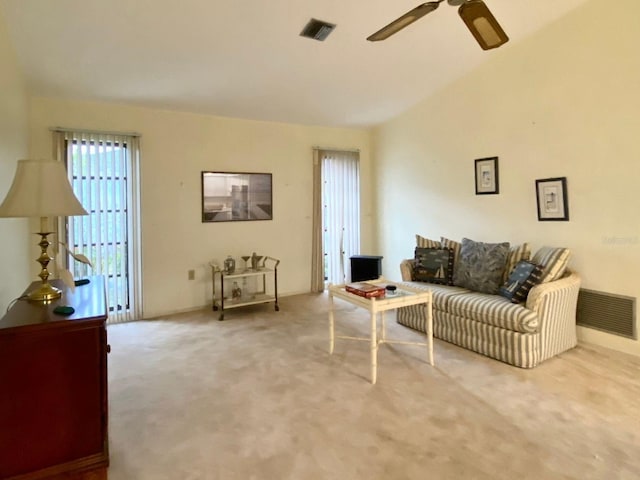 living room featuring carpet flooring and ceiling fan