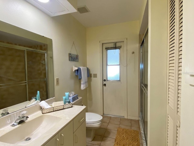 bathroom featuring walk in shower, tile patterned flooring, vanity, and toilet