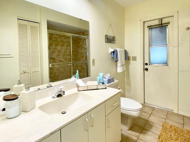 bathroom with tile patterned flooring, vanity, and toilet