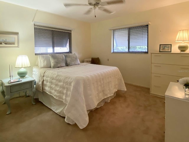 bedroom with ceiling fan and light carpet