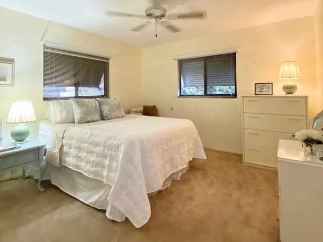 bedroom with ceiling fan and light colored carpet