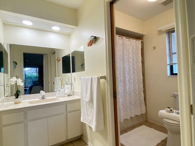 bathroom featuring tile patterned floors, a shower with curtain, vanity, and toilet