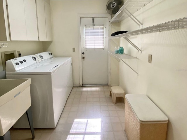 laundry room featuring cabinets, washing machine and dryer, and sink