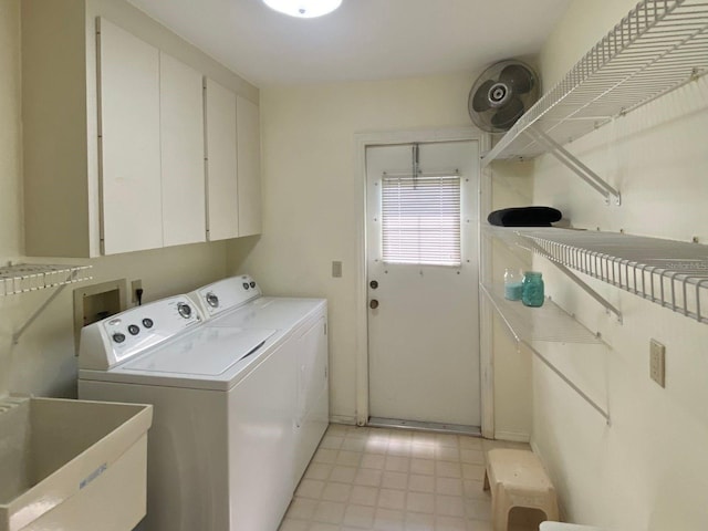 washroom featuring cabinets, sink, and washer and dryer