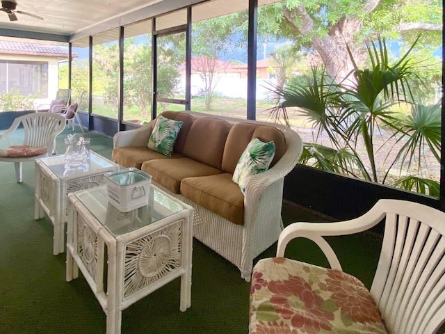 sunroom featuring ceiling fan