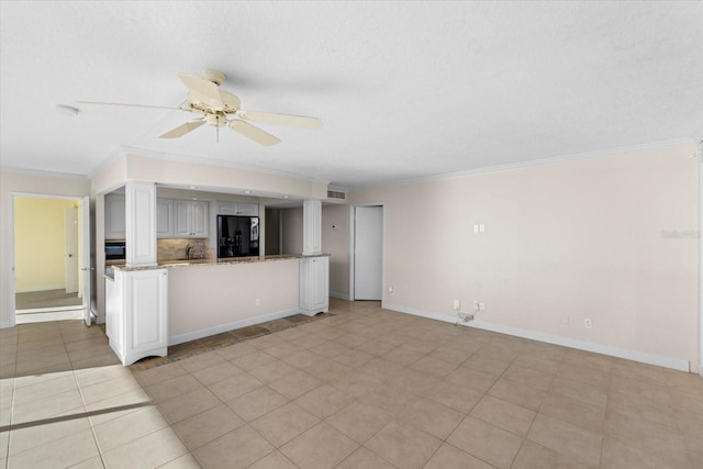 unfurnished living room featuring ceiling fan, light tile patterned floors, and ornamental molding