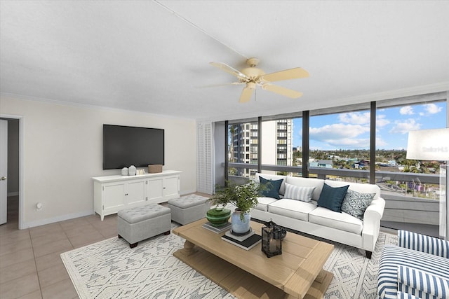 tiled living room featuring ceiling fan, floor to ceiling windows, and ornamental molding