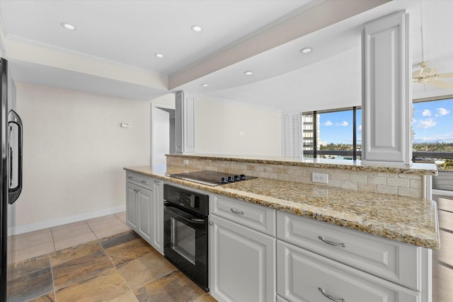 kitchen with backsplash, a healthy amount of sunlight, white cabinetry, and black appliances