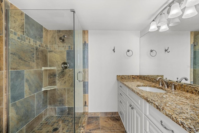 bathroom featuring vanity and a shower with shower door