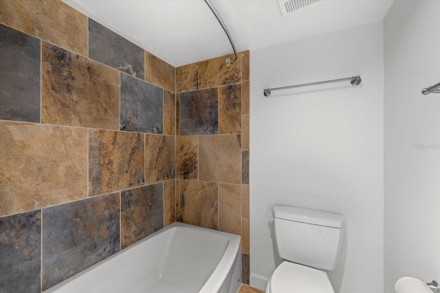 bathroom with shower / bathing tub combination and toilet