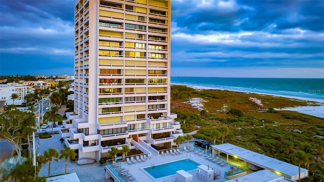 exterior space with a water view and a beach view