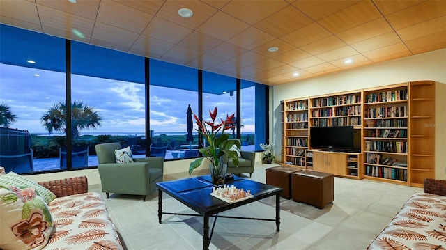 living room featuring light tile patterned floors and expansive windows